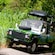 Passengers riding in an open air 4 by 4 Land Rover through a lush jungle setting